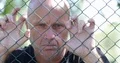 Man Portrait Disappointed and Disillusioned Hanging Desperate to a Metallic Fenc 4k or 4k+ Resolution