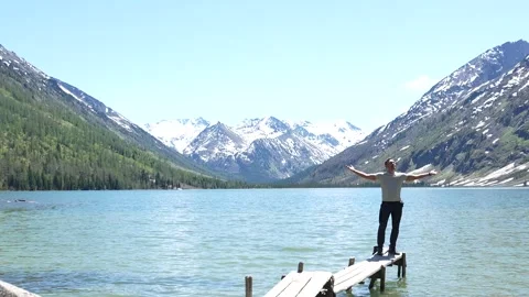 A man poses against the backdrop of the Multinsky lakes Stock Footage 315868250