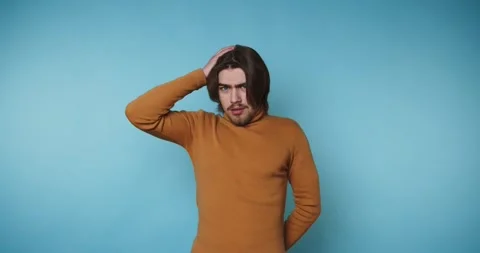 Man poses in four different frames showing various expressions against a bl.. Stock Footage 328249970