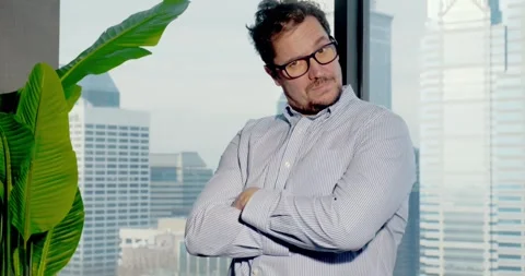 Man Poses Playfully in Skyscraper Office 스톡 동영상 323680197