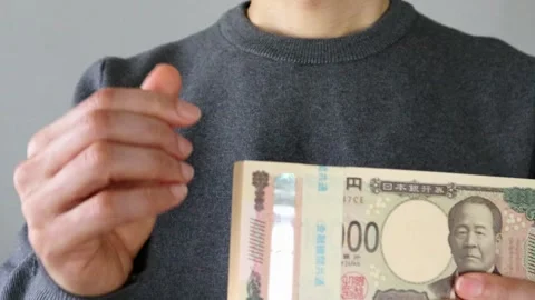 A man posing after taking out a wad of bills from his pay envelope Stock Footage 324548883