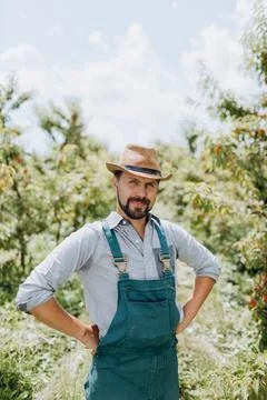 Man posing among peach trees Foto stock