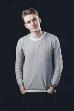 Man posing for the camera on dark background. Watching to camera Stock Photos