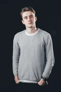 Man posing for the camera on dark background. Watching to camera Stock Photos