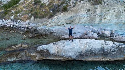 Man posing Coastal cliffs of the Adriatic Sea, Croatia, Makarska. Drone view Stock Photos