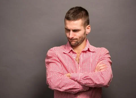 Man posing with crossed arms in studio Stock Photos
