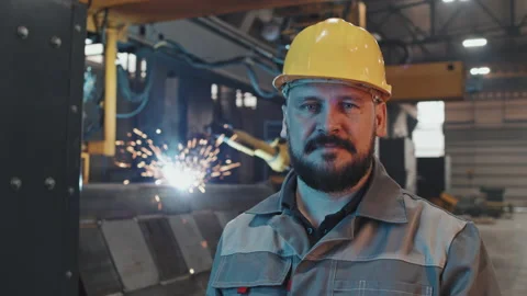 Man Posing in Foreground of Welding Stock Footage 197590786