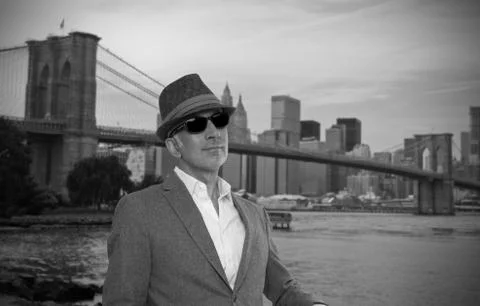 Man posing in front of Brooklyn Bridge Stock Photos