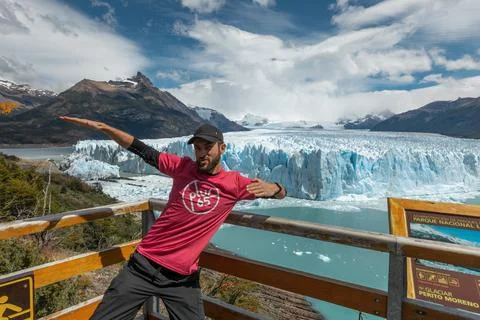 A man is posing in front of Perito Moreno Glacier Stock Photos