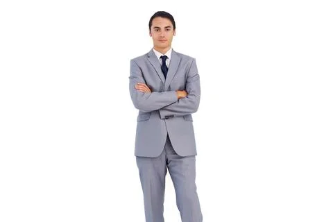 Man posing full-length in studio, wearing light-gray suit with white shirt and Foto stock