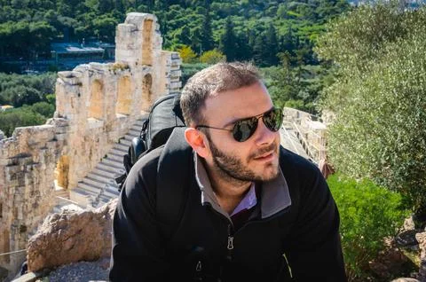 Man posing at Herodes Atticus Odeon in Acropolis, Athens, Greece. Stock Photos
