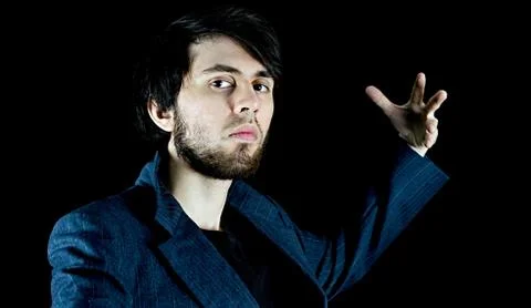Man posing with his left hand up, with style Stock Photos
