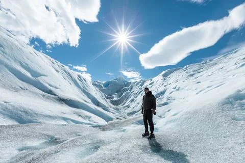 A man posing on the ice formation of the Perito Moreno Glacier Stock Photos