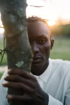 Man posing near the tree Stock Photos