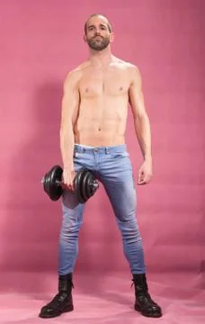 Man posing one dumbbell exercise holding arm Stock Photos