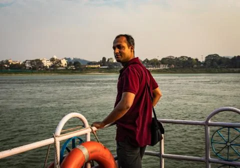 Man posing at ship deck with river horizon at evening Stock Photos