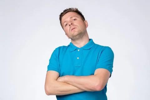 Man posing in studio with arms crossed and staring at camera with arrogant Stock Photos