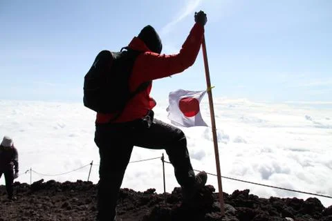 Man posing on Summit of Mt. Fuji Stock Photos