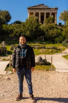 Man posing at Temple of Hephaestus in Ancient Agora, Athens, Greece. Stock Photos