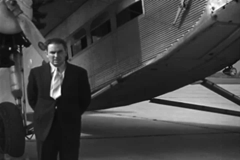 Man posing under starboard engine and man looks at center engine - 1926 Stock Footage 94257633