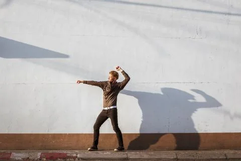 Man posing on white wall Stock Photos