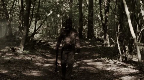 A man in a post-apocalyptic clothes in a black gas mask goes through the smoke. 스톡 동영상 65945573
