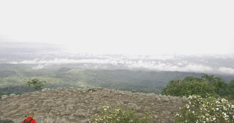 Man posting on mountain top aerial Stock Footage 89702490