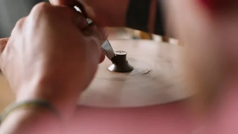 A man potter forms the handle of the lid of a clay teapot with a knife. craft Stock Footage 145534537