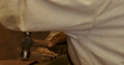 Man pounding a patina sheet of copper with a metal hammer Stock Footage 102721759
