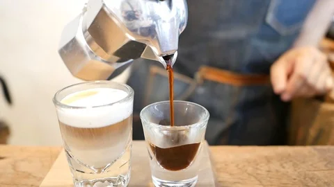 Man pour black coffee from silver moka pot, home brewing style Stock-Footage 90456433