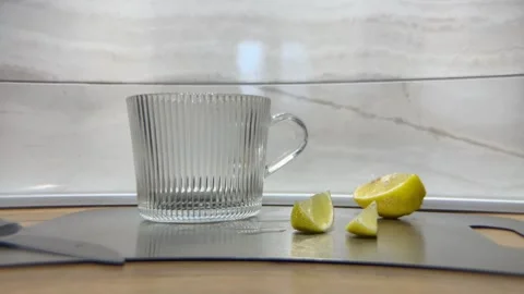 Man pour boiling water from kettle into mug brew tea bag and throw slice lemon Stock Footage 337647095
