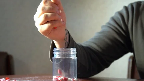 Man pour into a jar of pills Video stock 86045187
