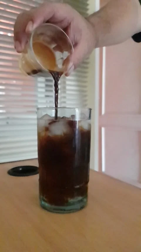 A man pour a small cup of espresso to the ice water. Stock Footage 327253055
