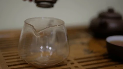 Man pour tea into the chahai through a sieve. Chinese tea ceremony Stock Footage 99573609