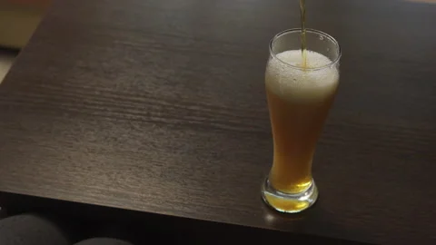 The man poured himself a fresh beer and took a sip Stock Footage 221185754