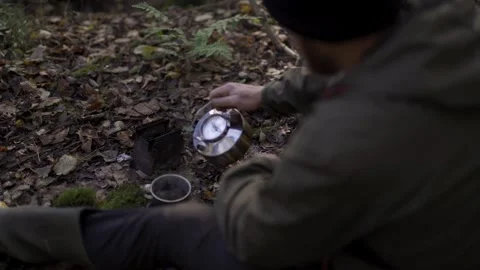 A man pouring and drinking coffee in the woods Vidéo 260244847