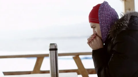 Man pouring and drinking tea from a thermos Stock Footage 70800474