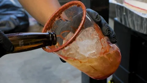 Man Pouring Beer Into Cup For Michelada Stock Footage 342163496