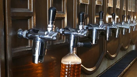 Man pouring beer into a plastic bottle. Beer bottling plant.  Stock Footage 113057796