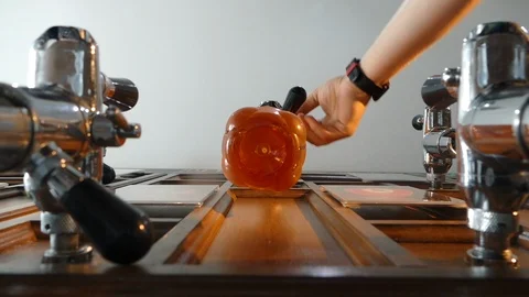 Man pouring beer into a plastic bottle. Removes the bottle from the tap and Stock Footage 113060652