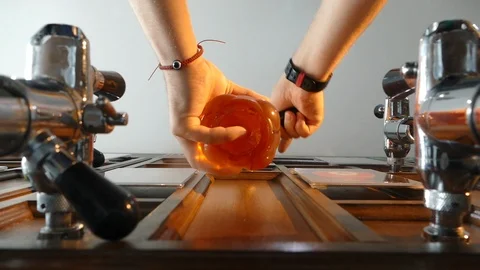 Man pouring beer into a plastic bottle. Removes the bottle from the tap and Stock Footage 113060802