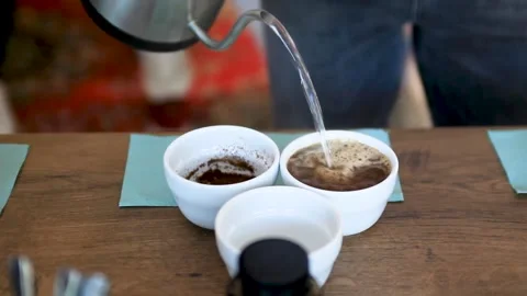 Man pouring boiling water into a cup of coffee Stock Footage 197484686