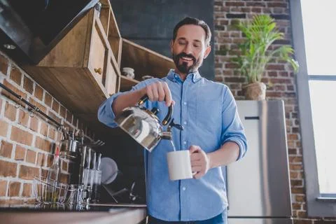 Man pouring coffee into the cup Stock Photos