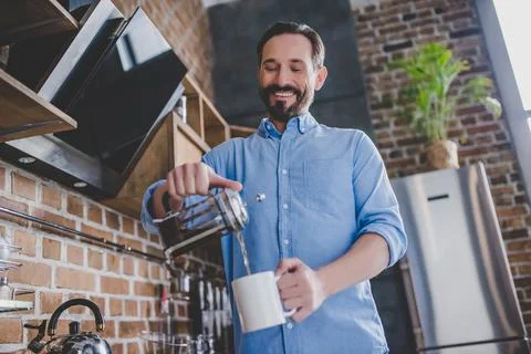 Man pouring coffee into the cup Stock Photos
