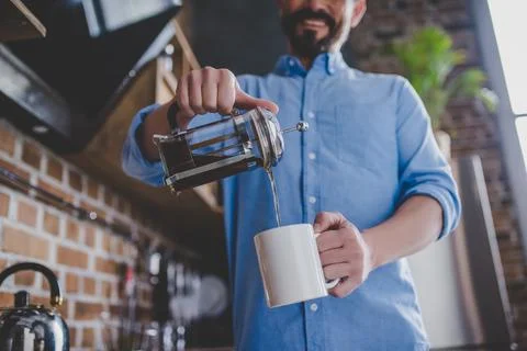 Man pouring coffee into the cup Stock Photos