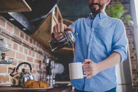 Man pouring coffee into the cup Stock Photos