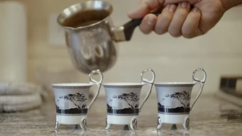 Man is pouring coffee into cups Video stock 219019562