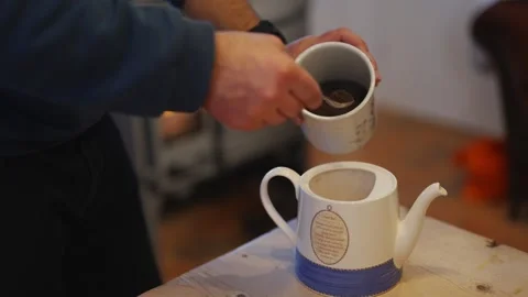 A man is pouring coffee into a white cup Video stock 295370339