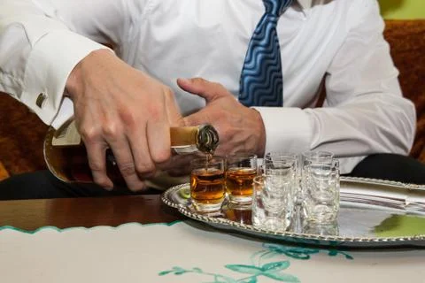 Man is pouring cognac Stock Photos