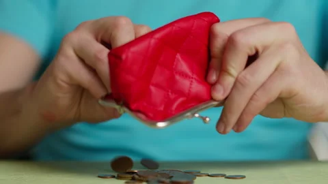 Man pouring coins onto the table from a red wallet, close-up Stock Footage 144788219